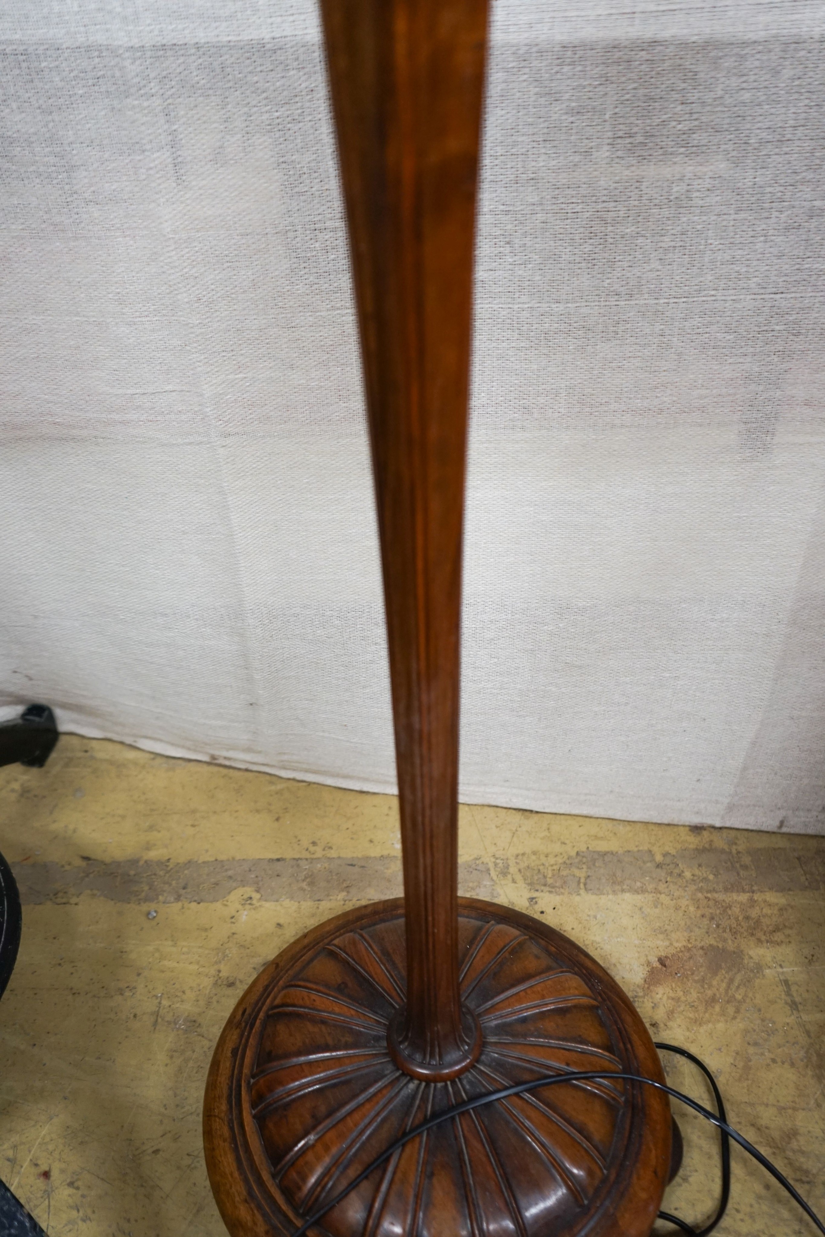 A turned and carved walnut standard lamp on circular base with bun feet, height excluding shade 132cm